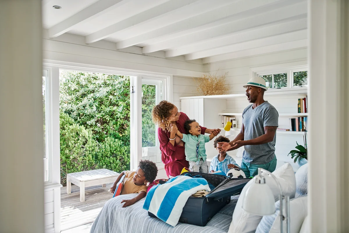 Family packing suitcase for vacation