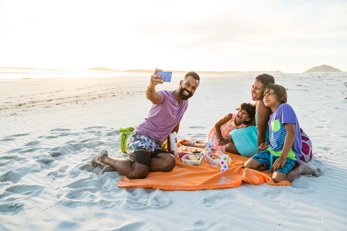 Family taking selfie on the beach
