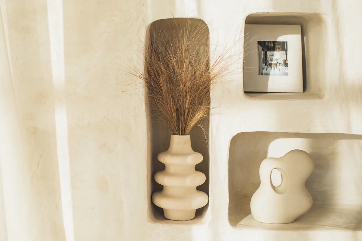 Clay pot and jug stading in shelves in beige clay