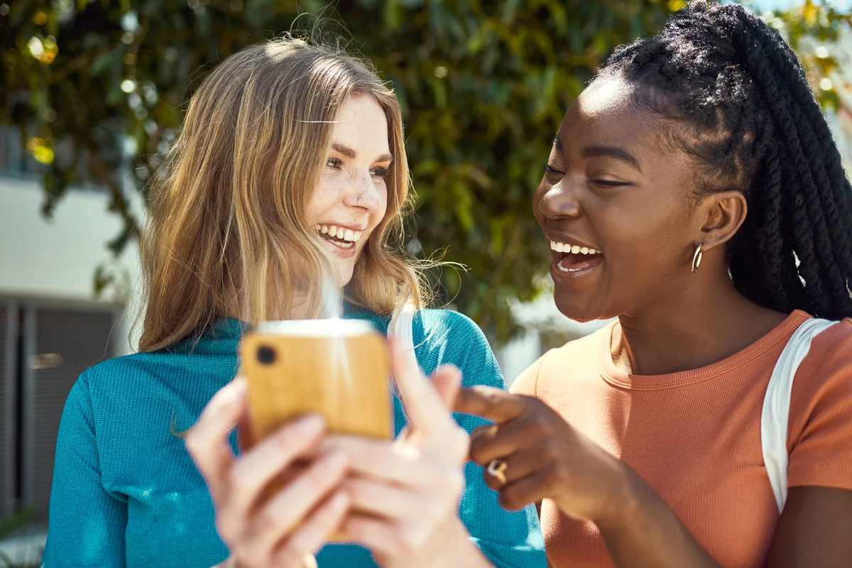 Two young women using a smartphone