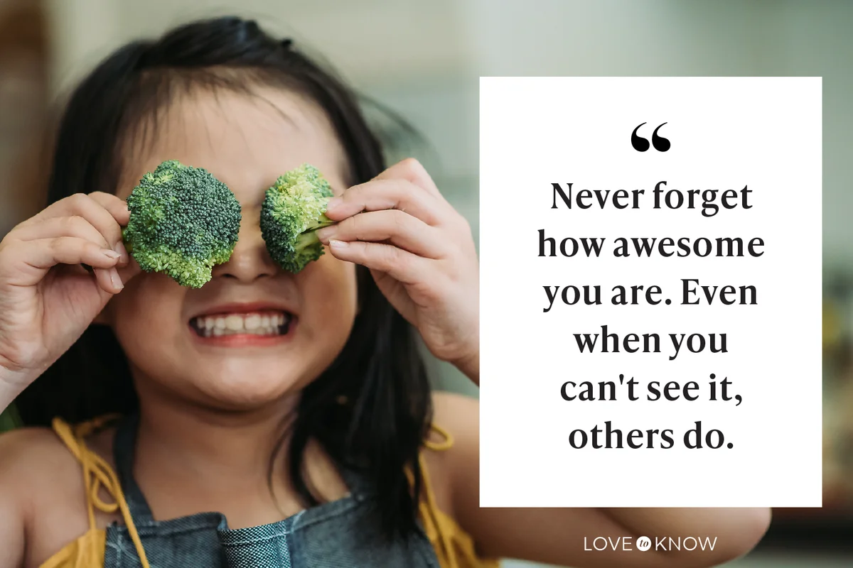 child act cute with hand holding broccoli putting in front of her eyes