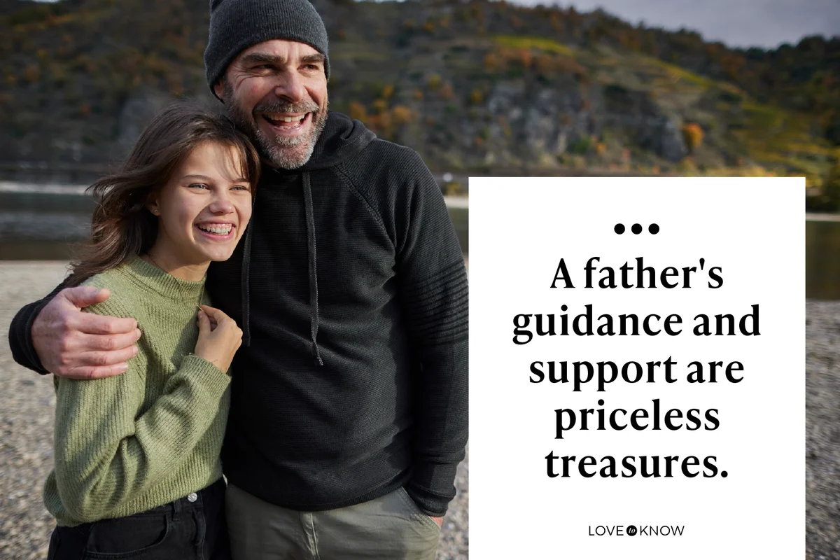 Happy father embracing daughter at a riverbank