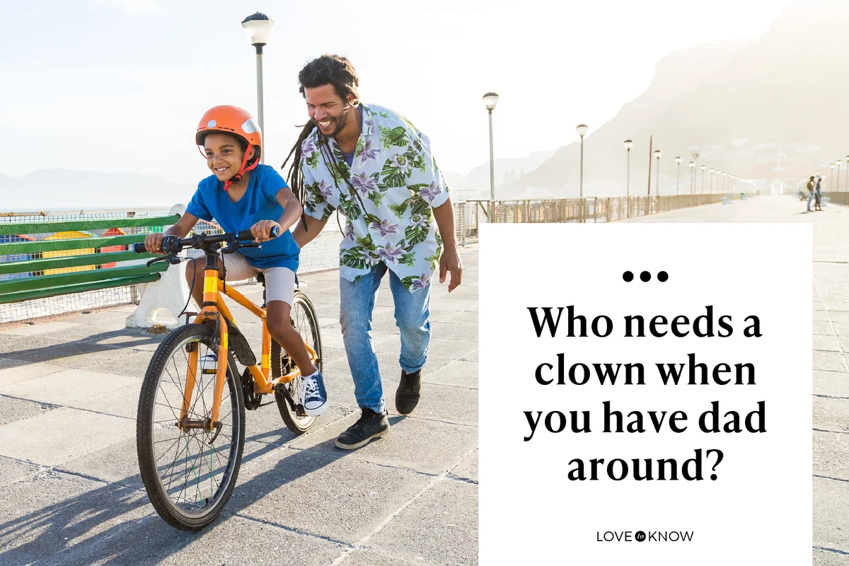 Boy riding a bike with his dad