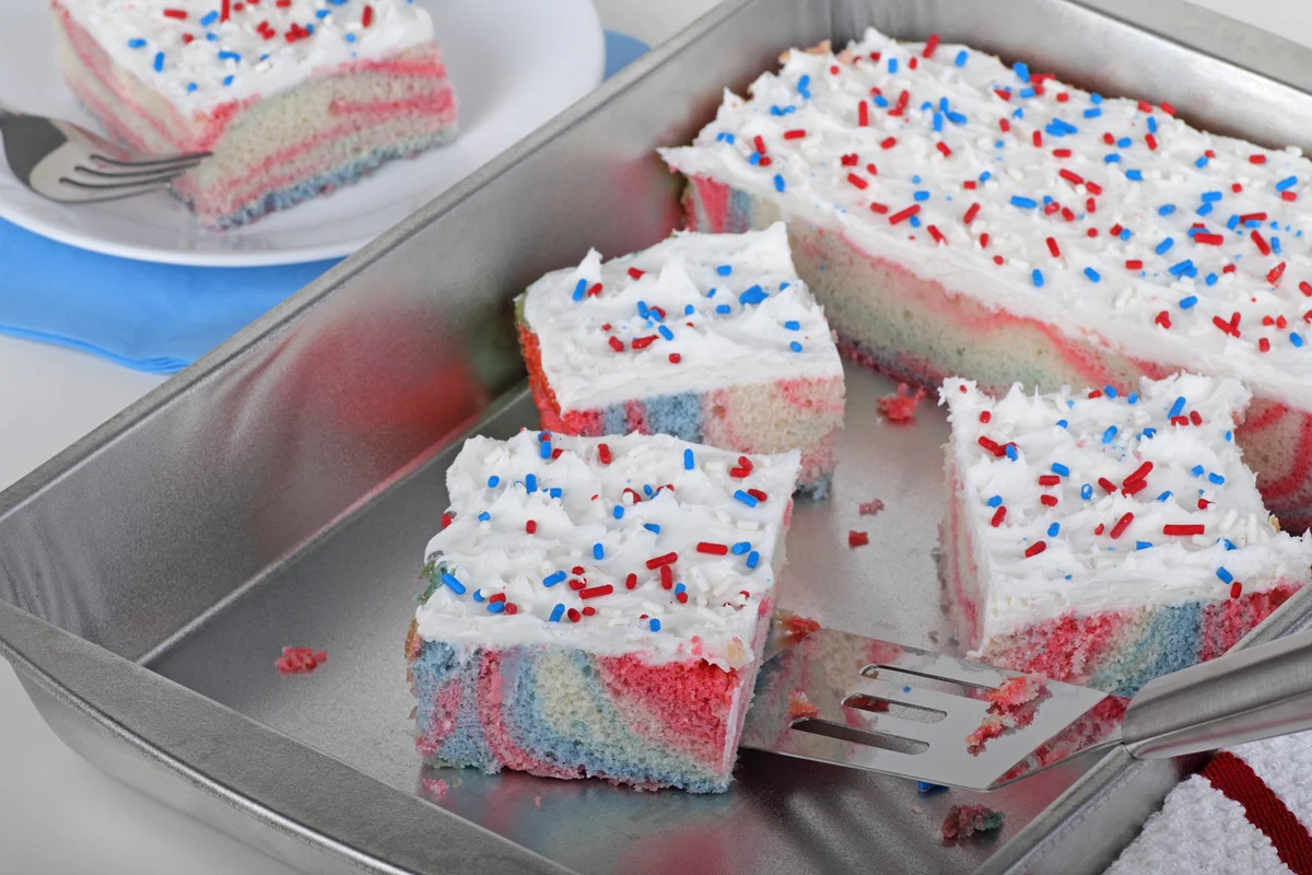 Pieces of red white and blue cake in a cake pan