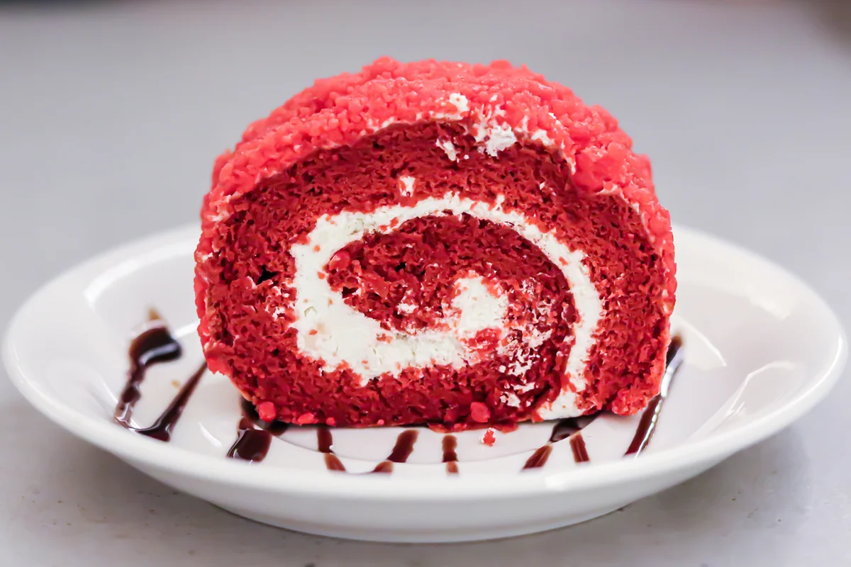 Red velvet swiss roll Served In Plate On Table