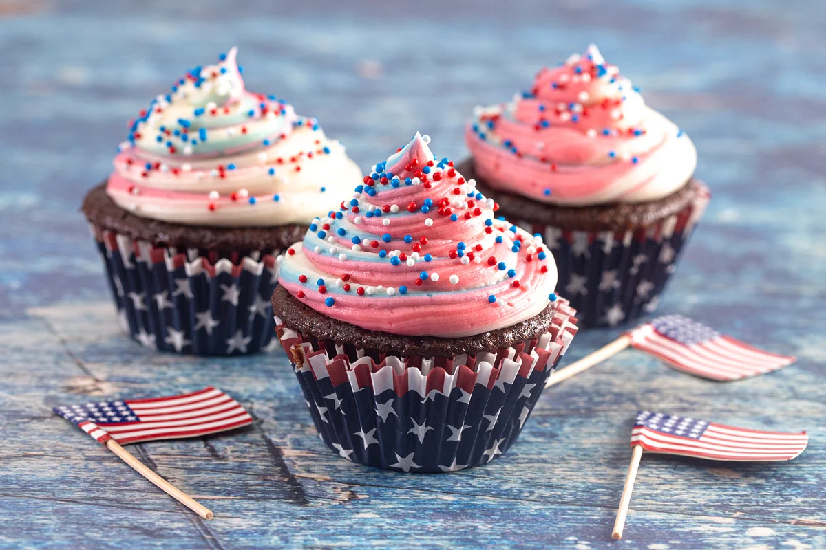American Themed Cupcakes with Flags on a Blue Wooden Table