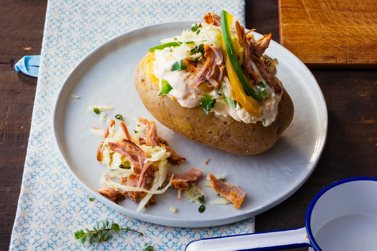 Baked potato with curd, sauerkraut, veal and vegetables