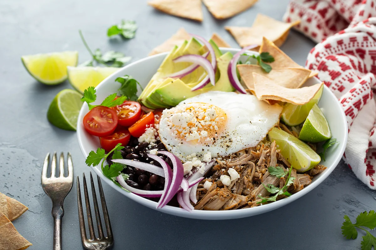 Breakfast burrito bowl with pork carnitas and rice