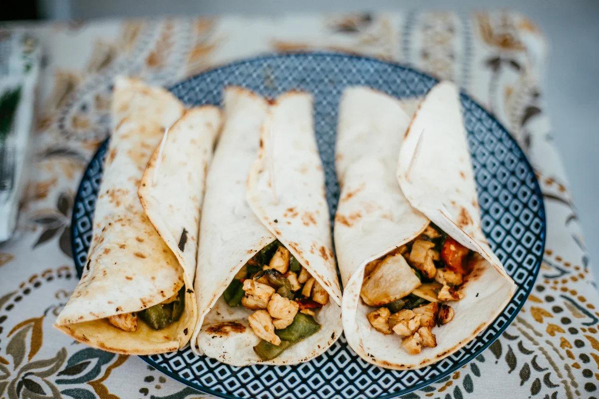 Wrapped chicken burritos on plate
