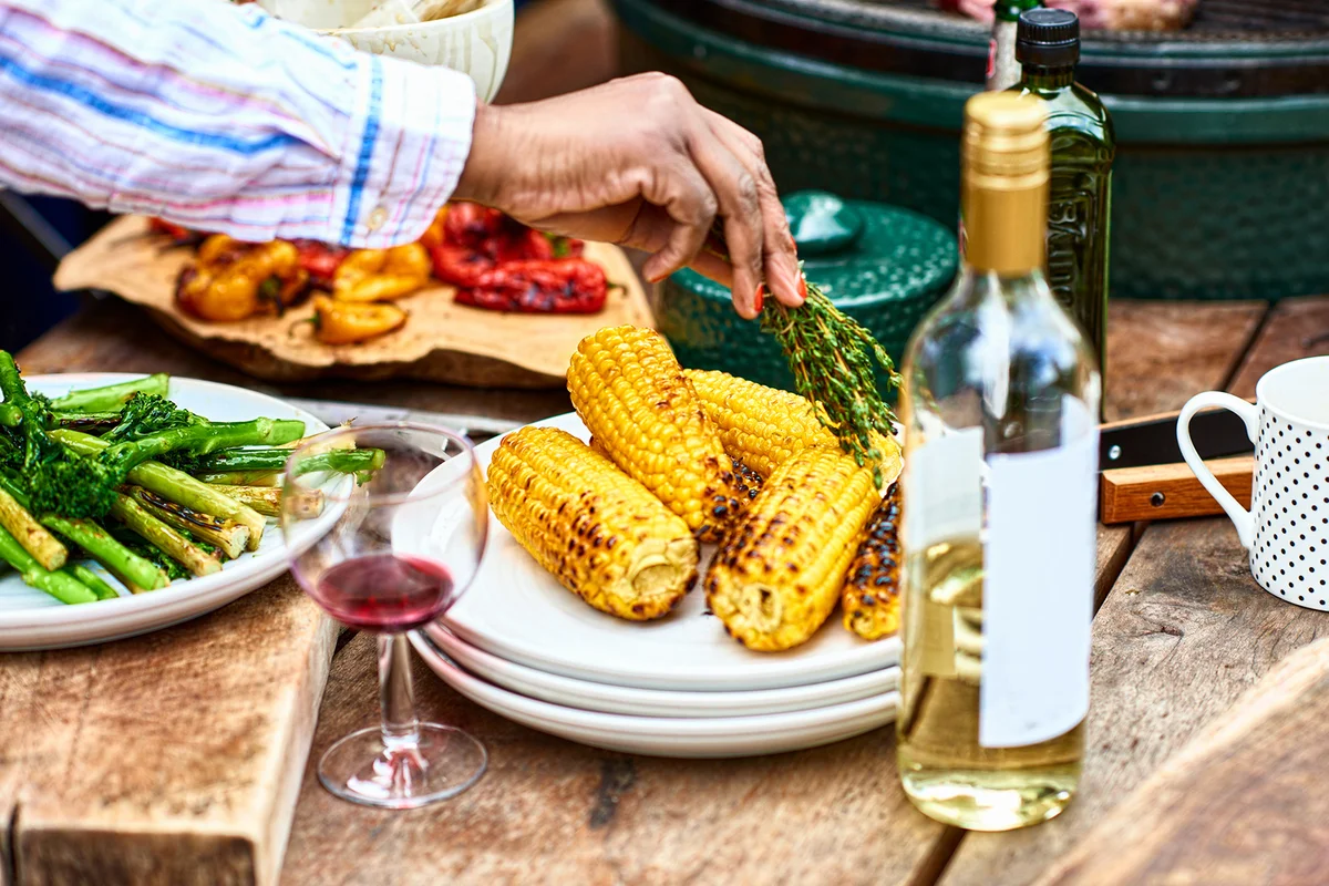 Freshly barbecued corn on the cob and herbs