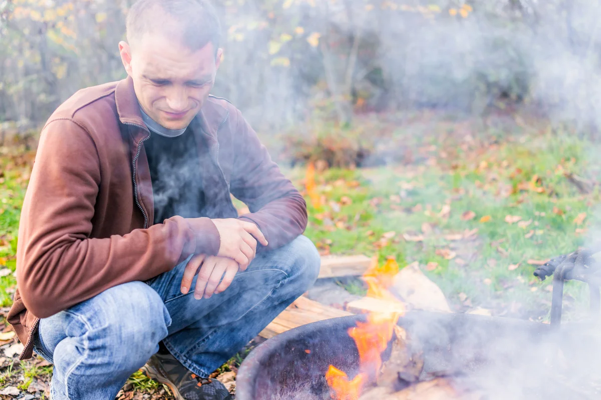 man by campfire