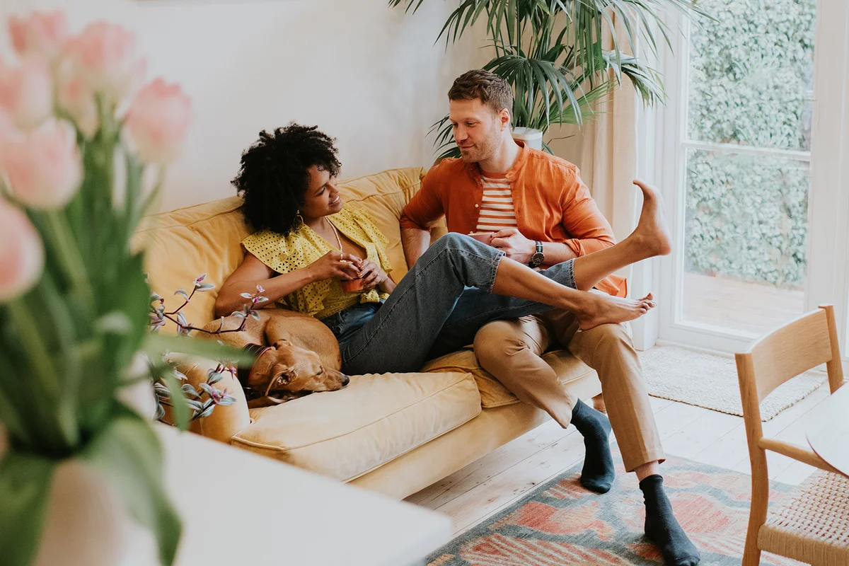Couple on sofa with their dog