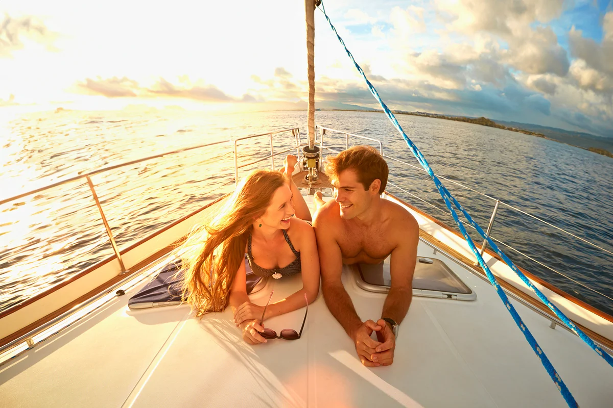 couple sunbathing on yacht deck