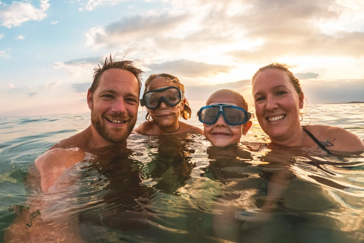 Family swimming and laughing in the sea