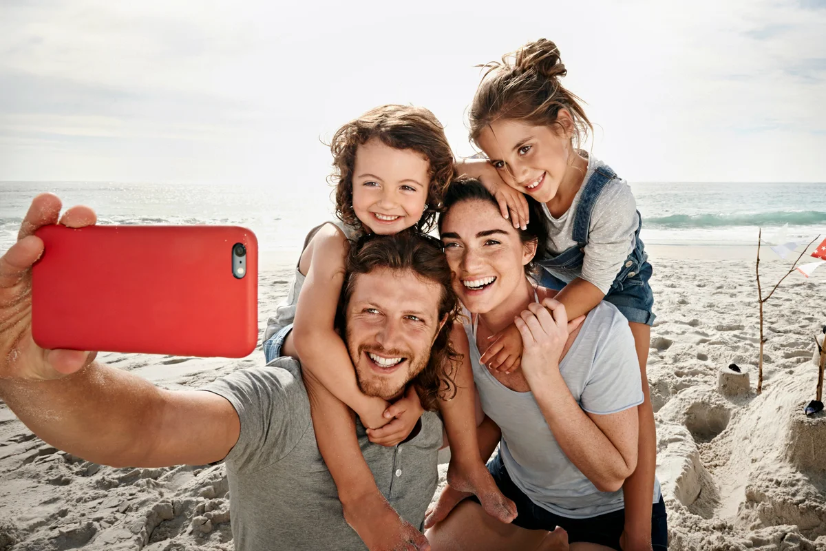 Family taking a selfie on the beach