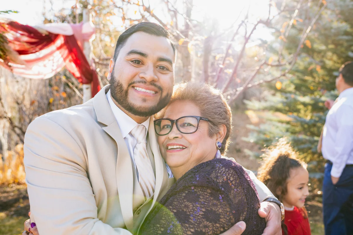 Groom and mother posing for wedding photo