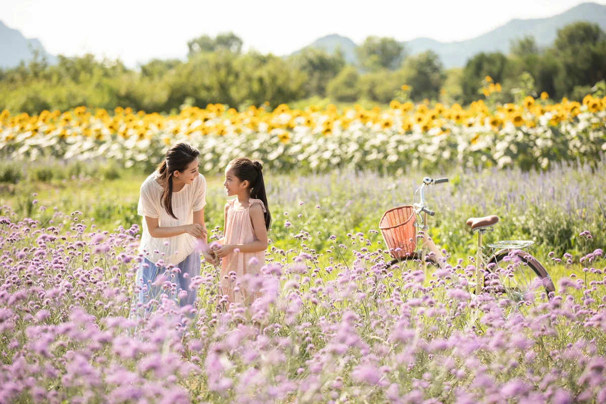 Mother and daughter in flower field