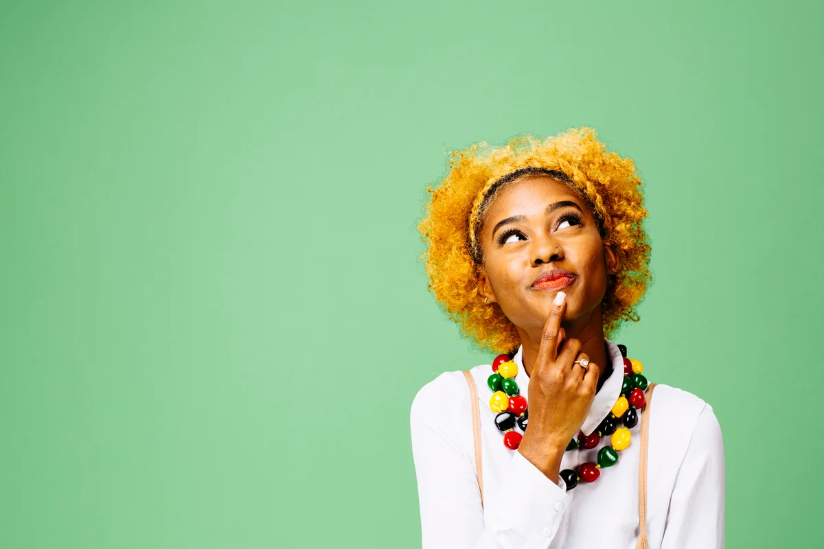 young woman looking up and thinking