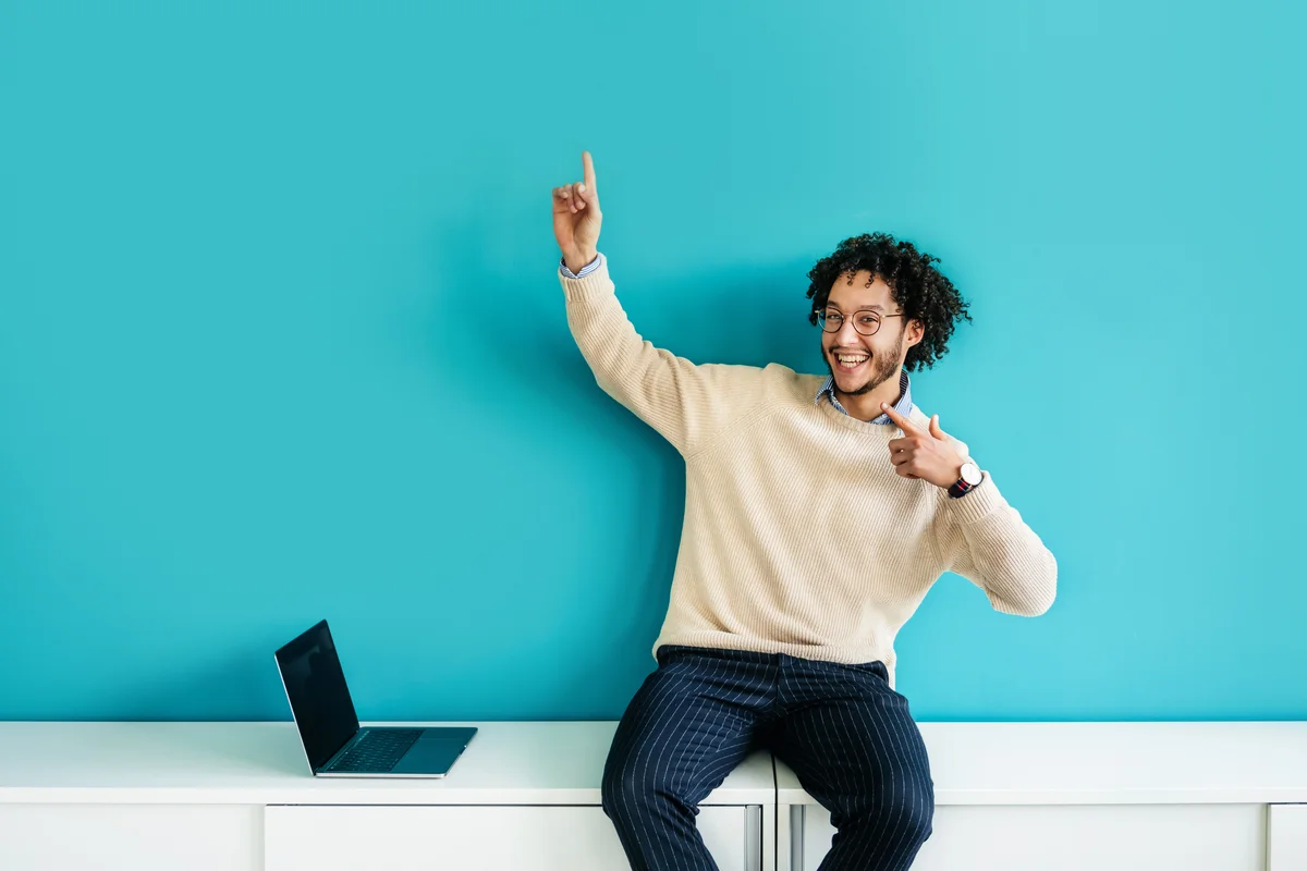 man smiling near a computer