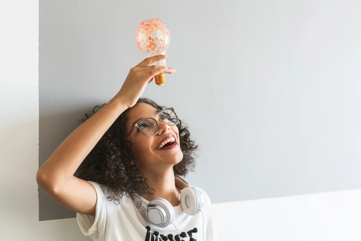 girl holding a lightbulb