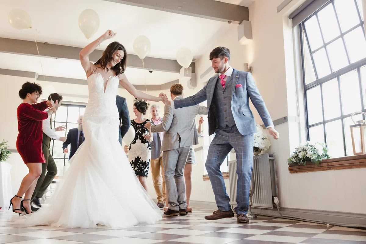 Newly wed couple dancing with all of their guests on their wedding day