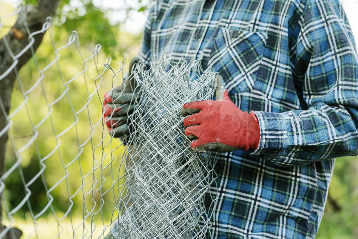 Man building a protective fence