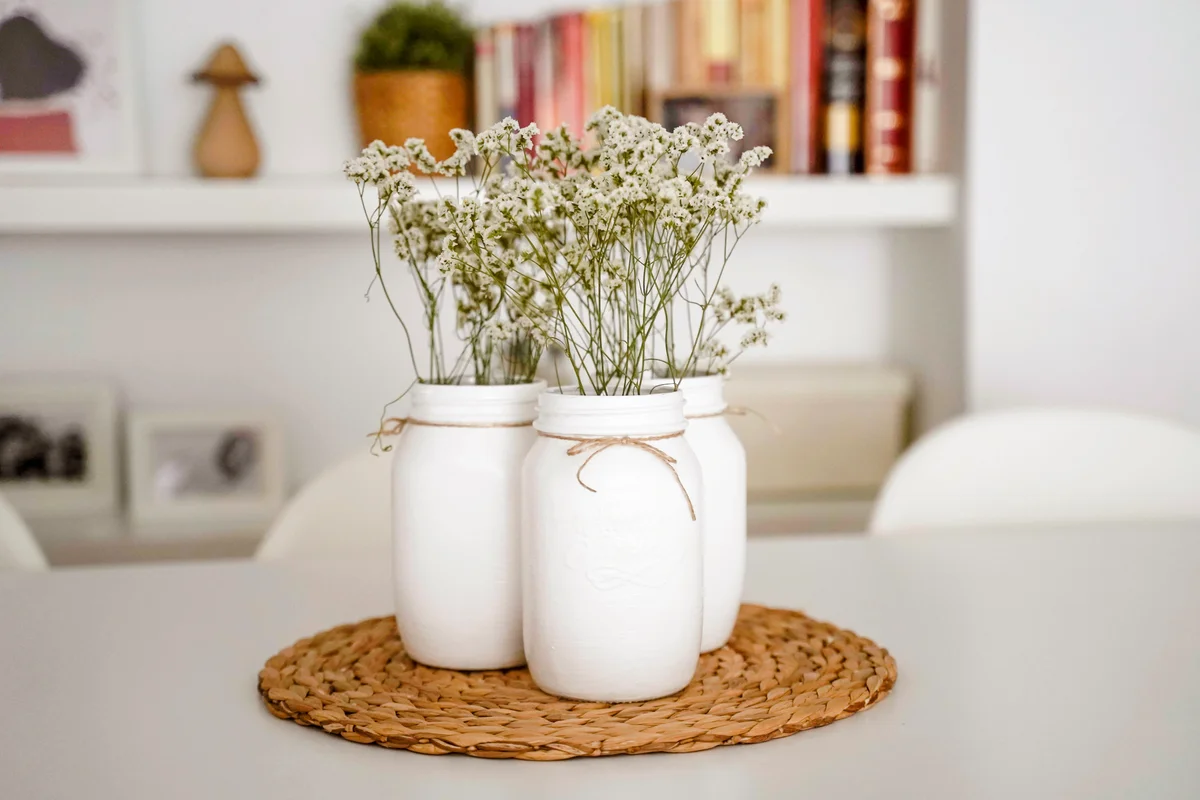 Mason jars painted white with flowers