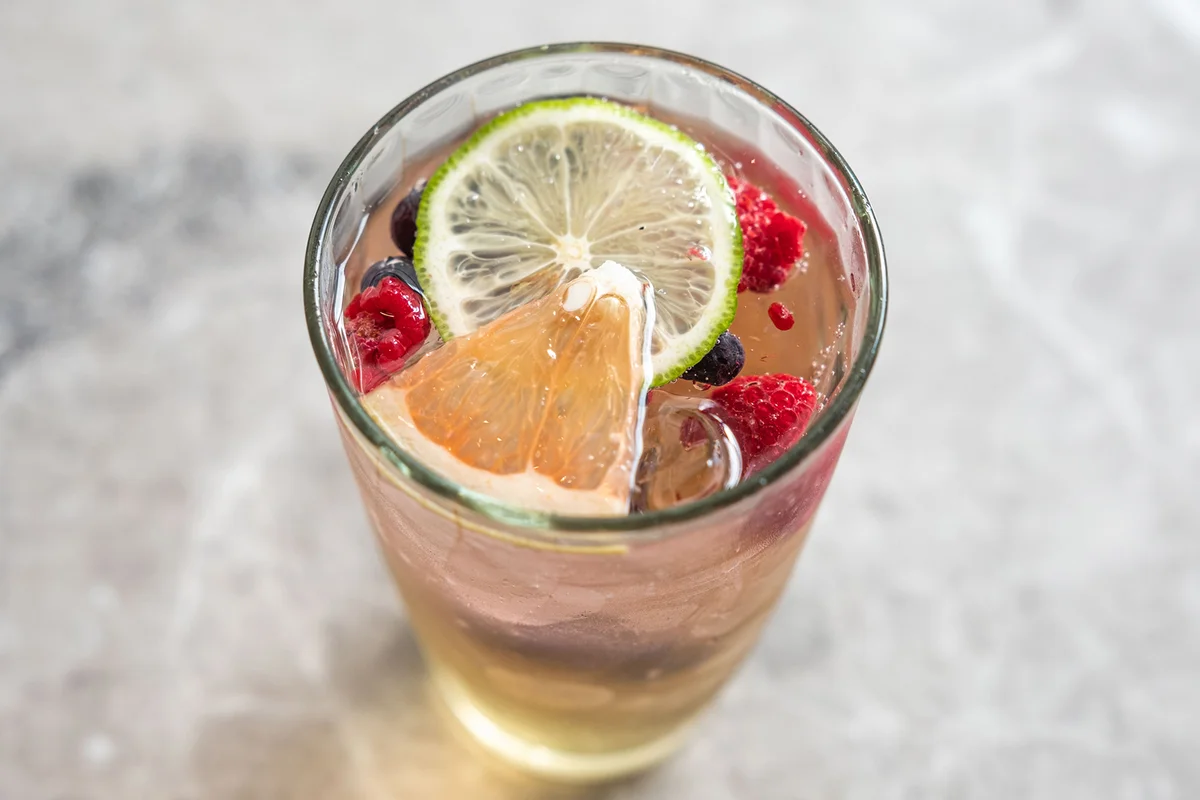 Berry Spritzer Pouring over Ice with Strawberry