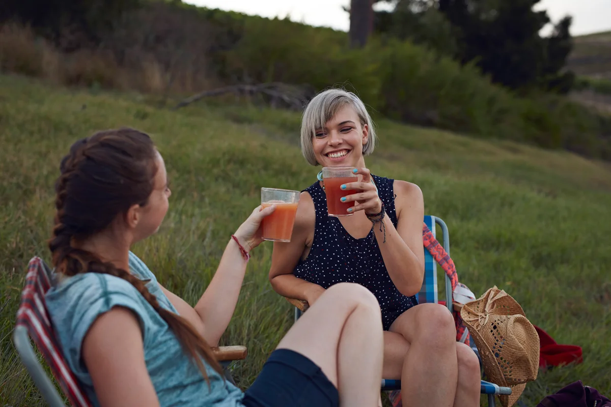 Two women toasting on camping trip