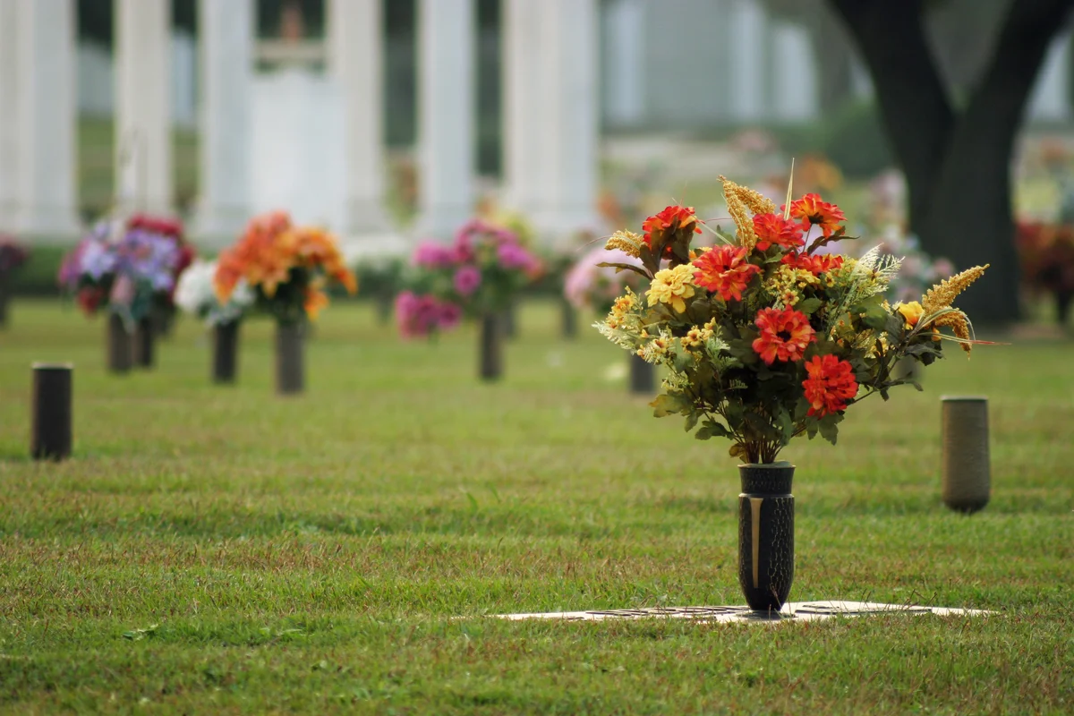 Fresh flowers in vases at a cemetery