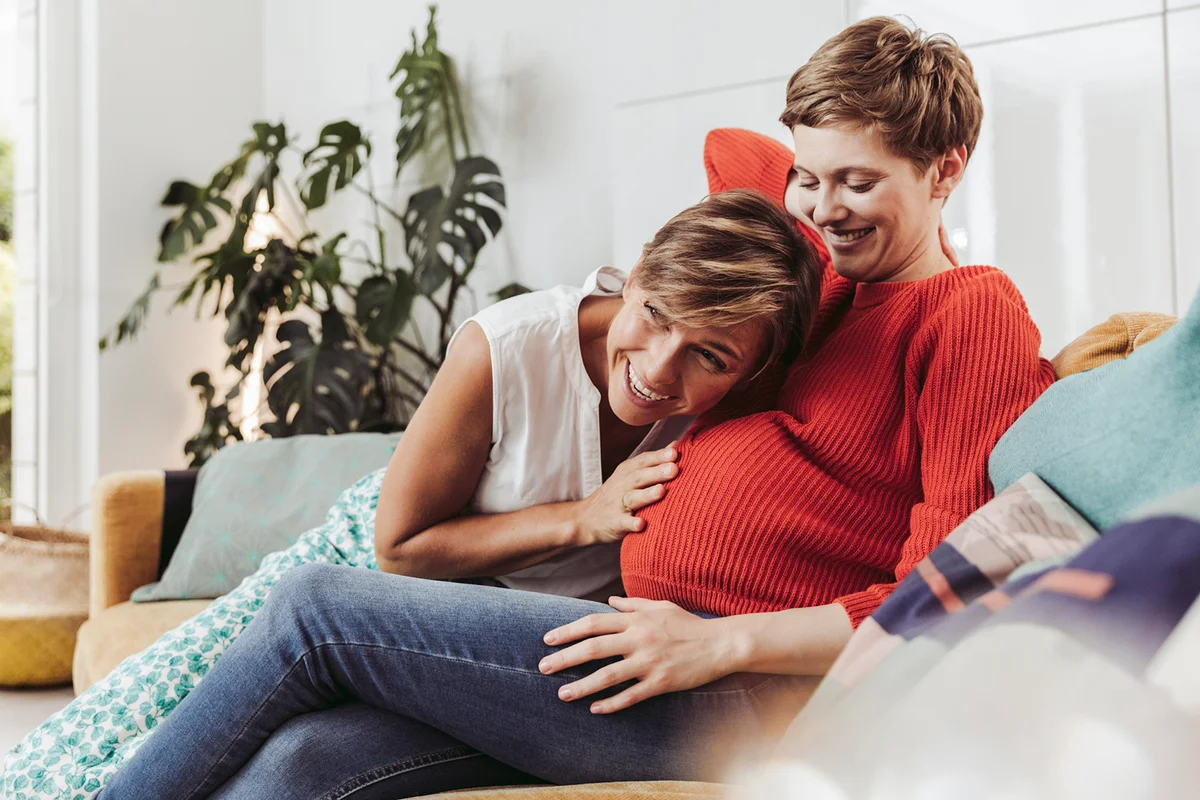 Happy couple feeling movements of baby belly of the expectant mother