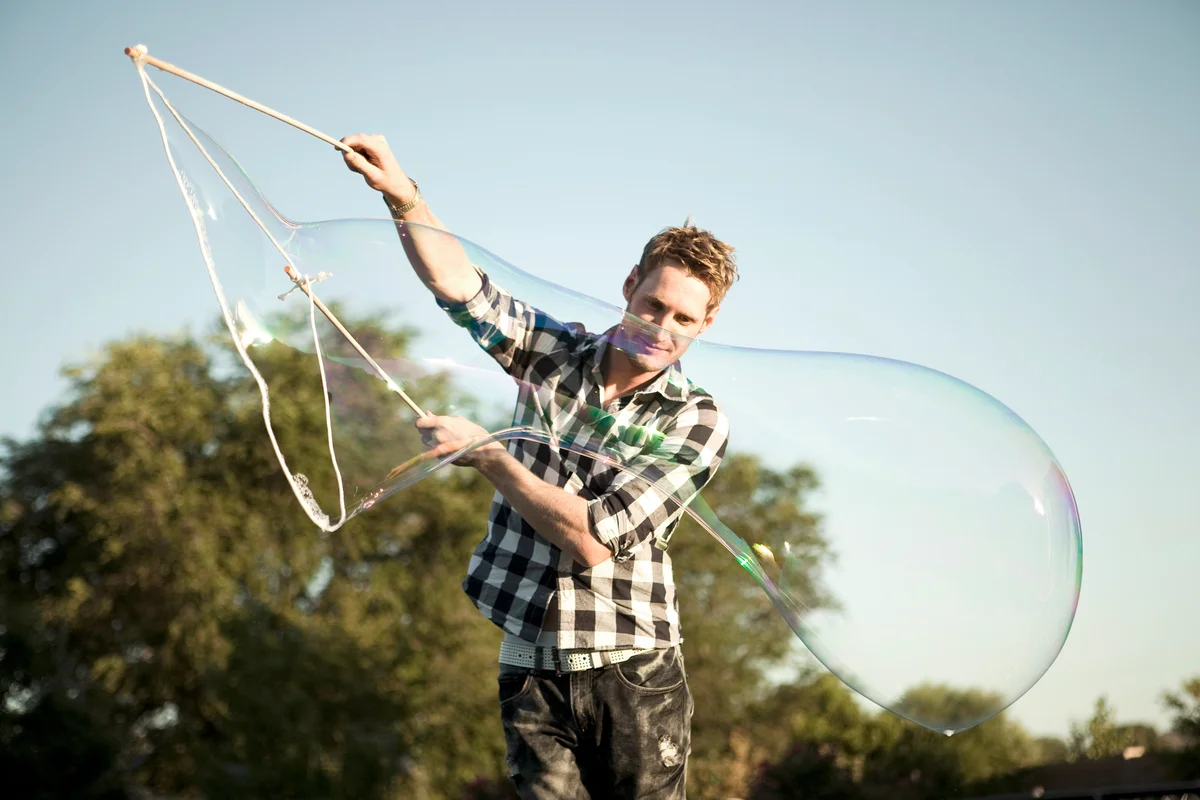 Man making large soap bubble