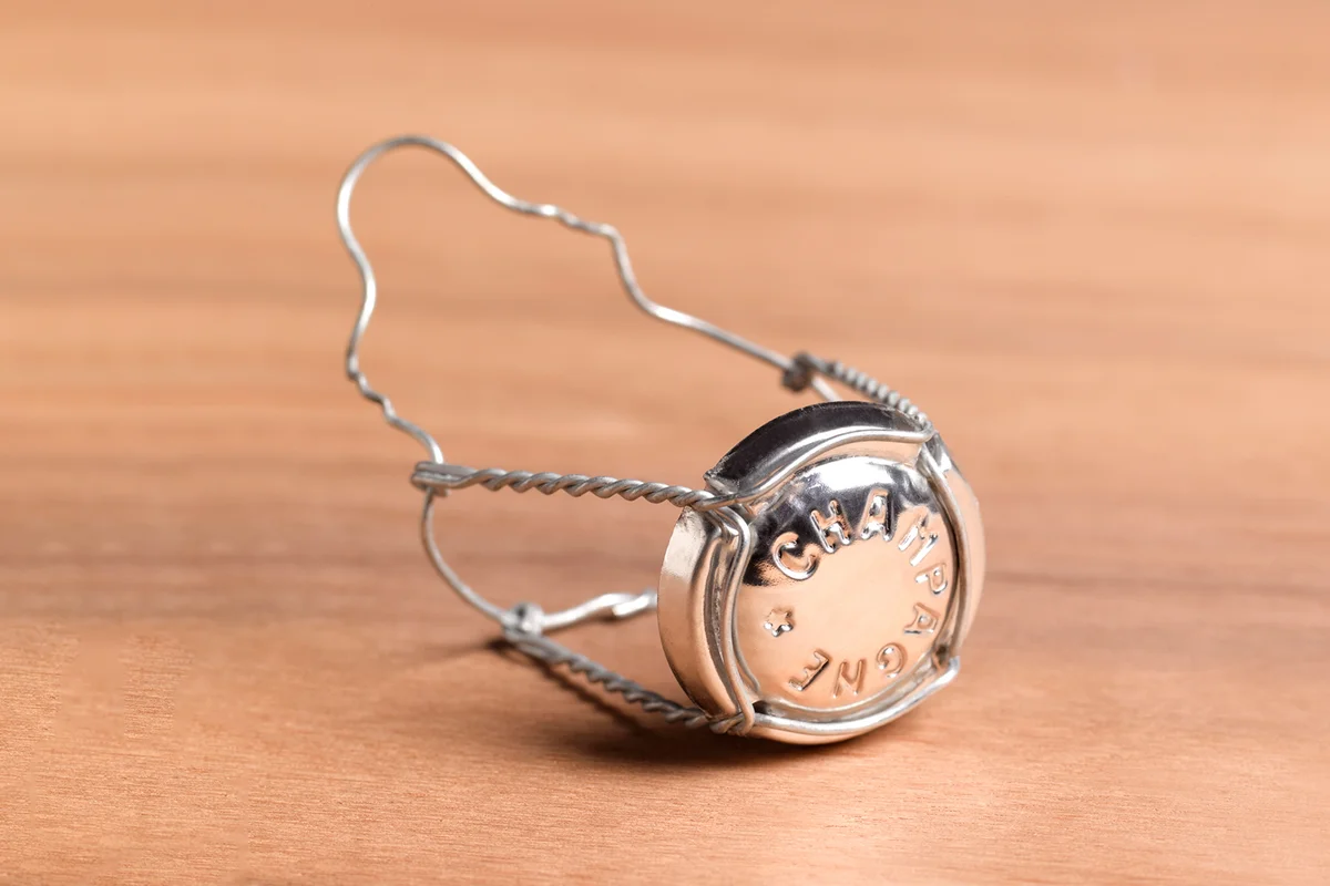 Champagne muselet on wooden background