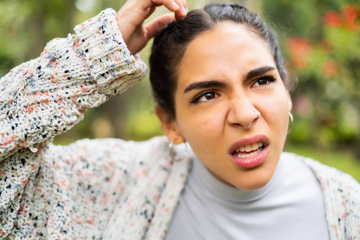 Young Latino woman making a face looking uncertain
