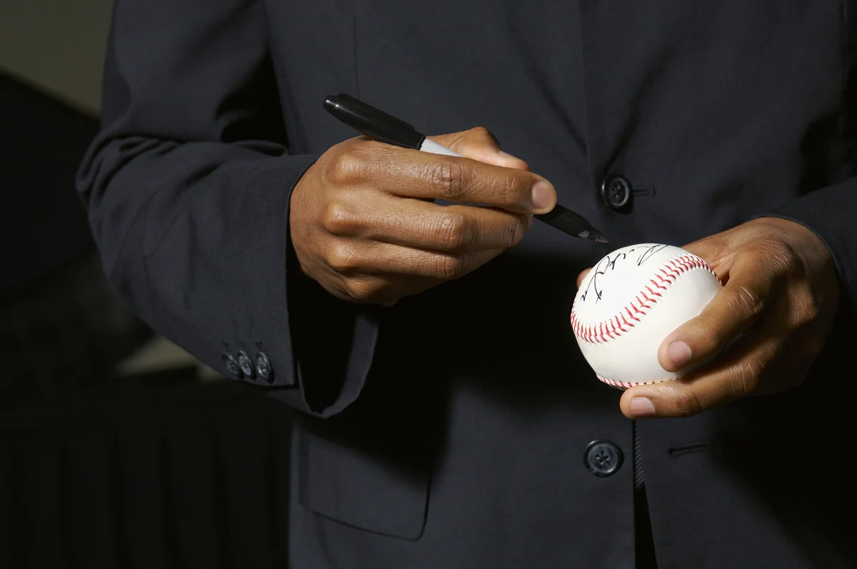 autographing a baseball