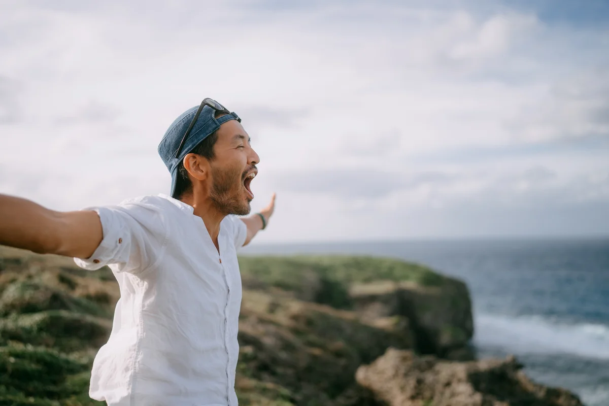 man standing by the sea smiling