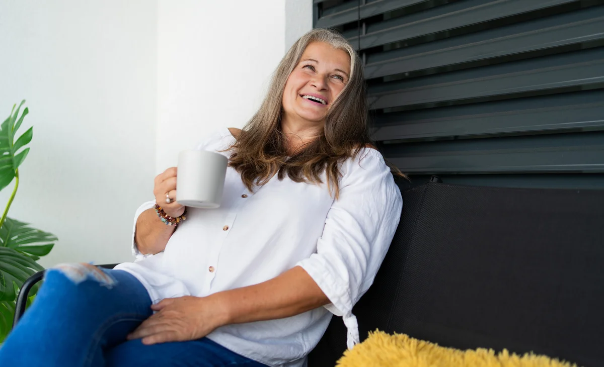 woman on balcony drinking coffee