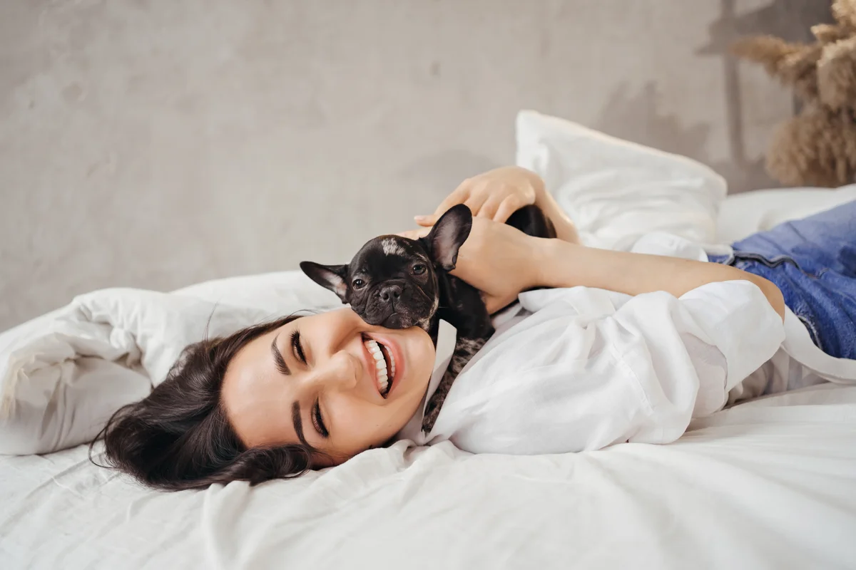 happy woman with Frenchie puppy