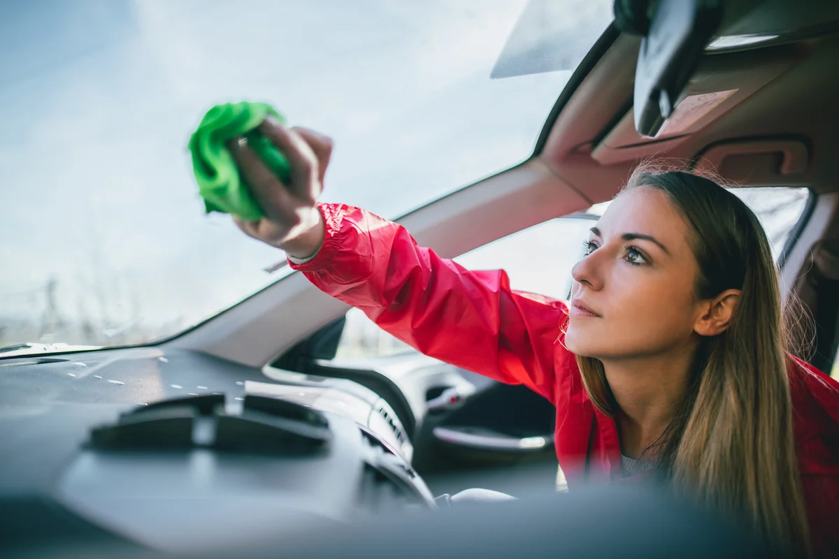 woman cleaning car window