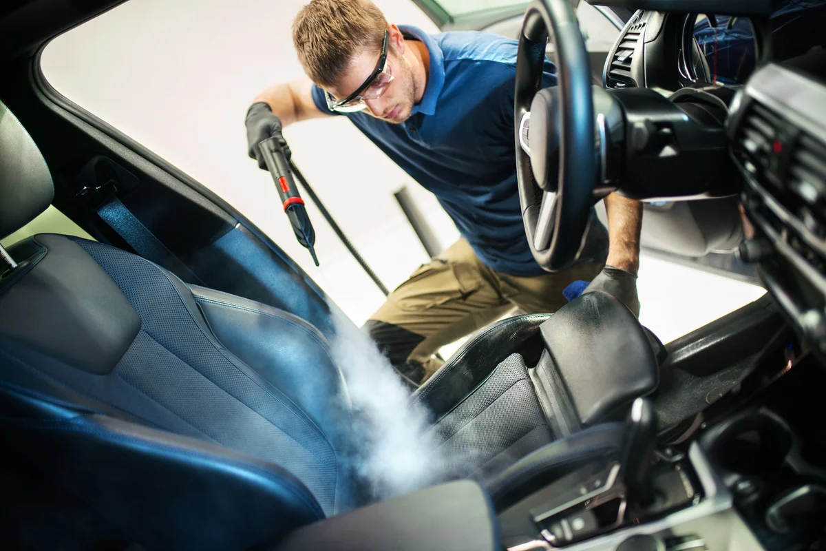 man detailing a car