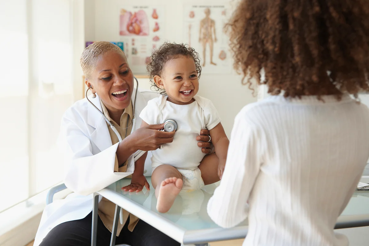 Doctor listening to baby's breathing with stethoscope