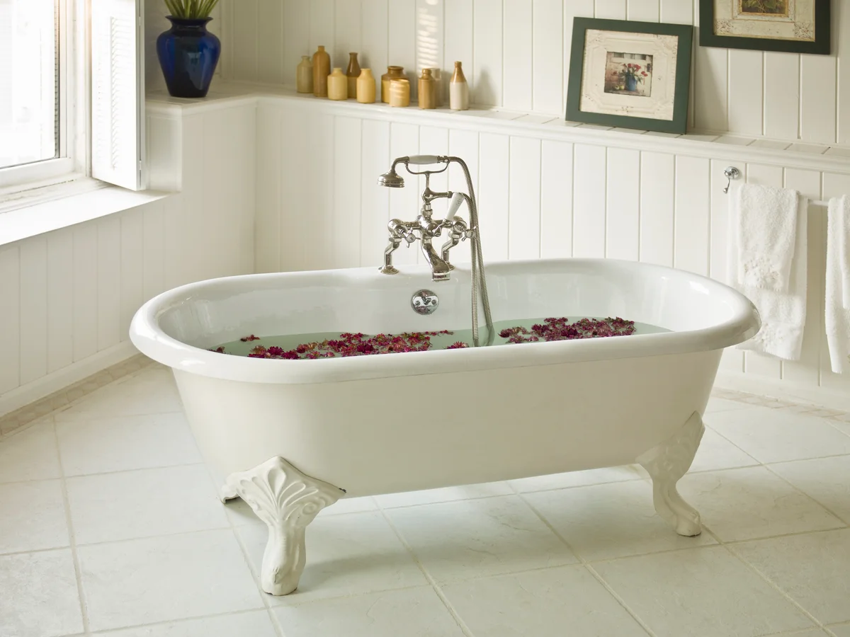 vintage design bathroom shelves behind a claw foot tub