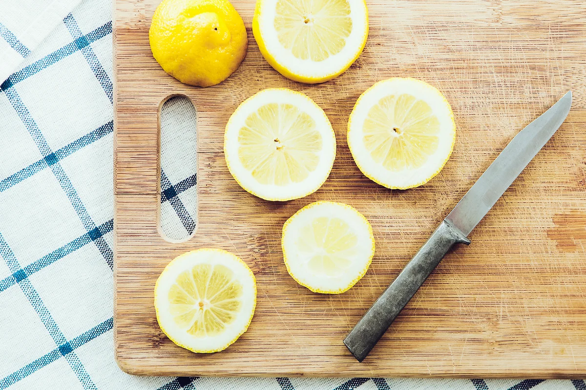 Sliced lemon on wood cutting board