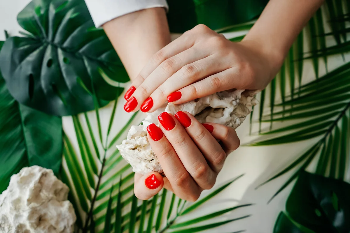 Manicured woman's nails with red nail polish