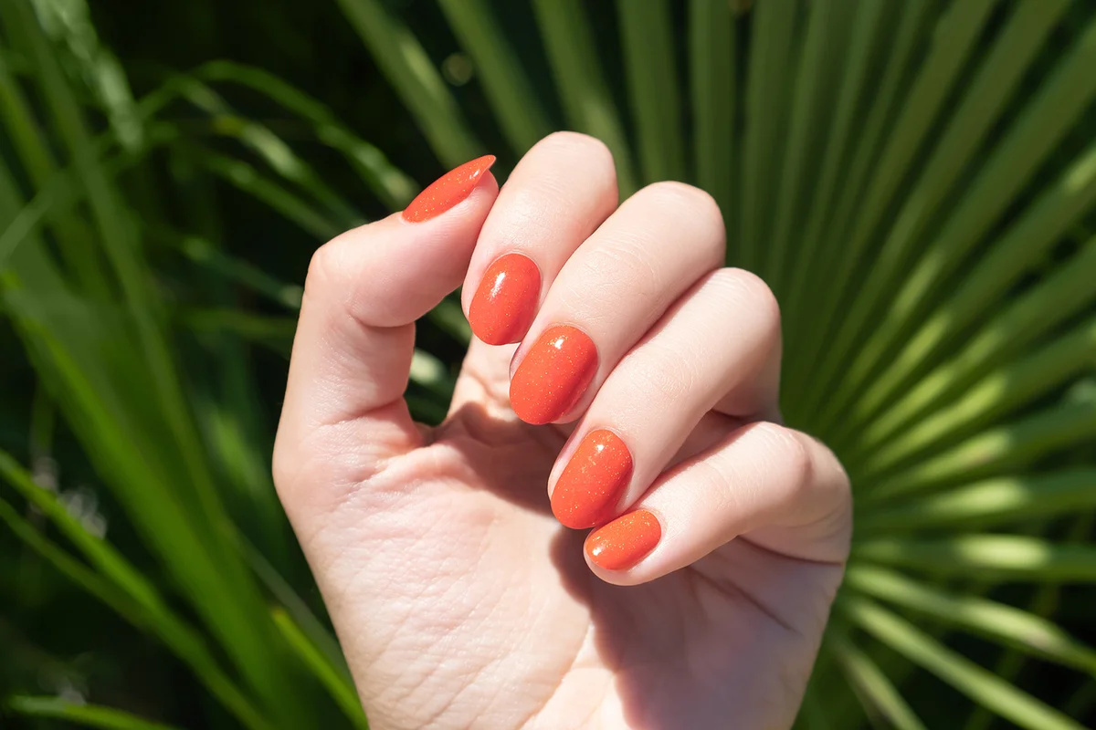 Orange nail polish manicure