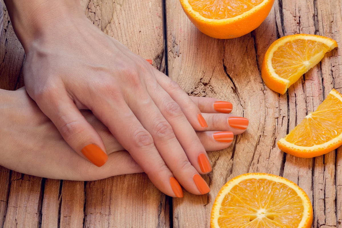 Orange manicure and oranges