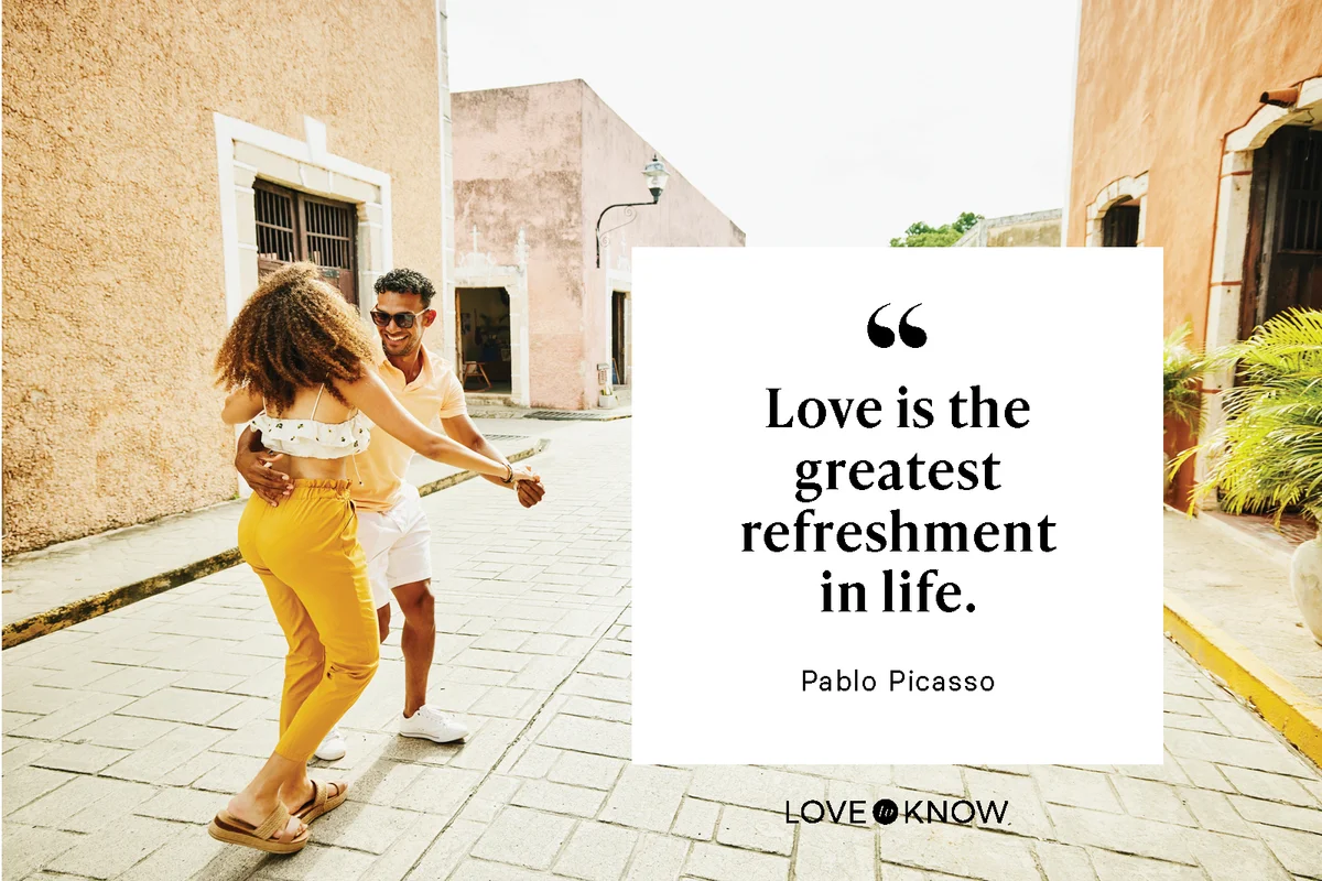 Smiling couple dancing in street