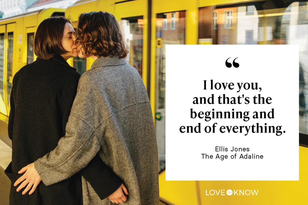 Couple kissing while standing by yellow train