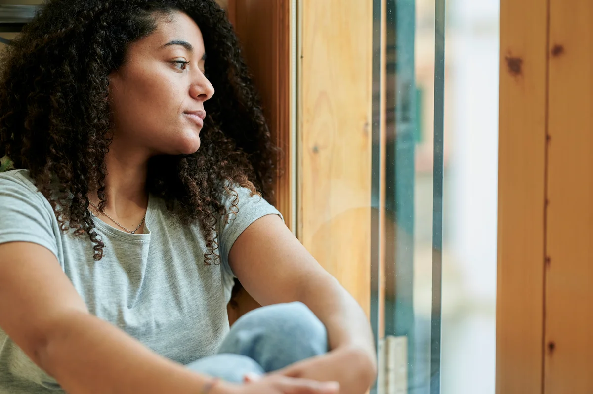 woman looking out window
