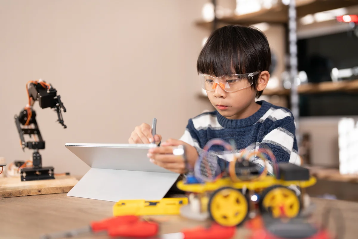 little boy programming a robot